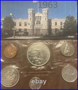 Canadian mint 1963 and 1964 coins with the 1964 $1 commemorating Charlottetown
